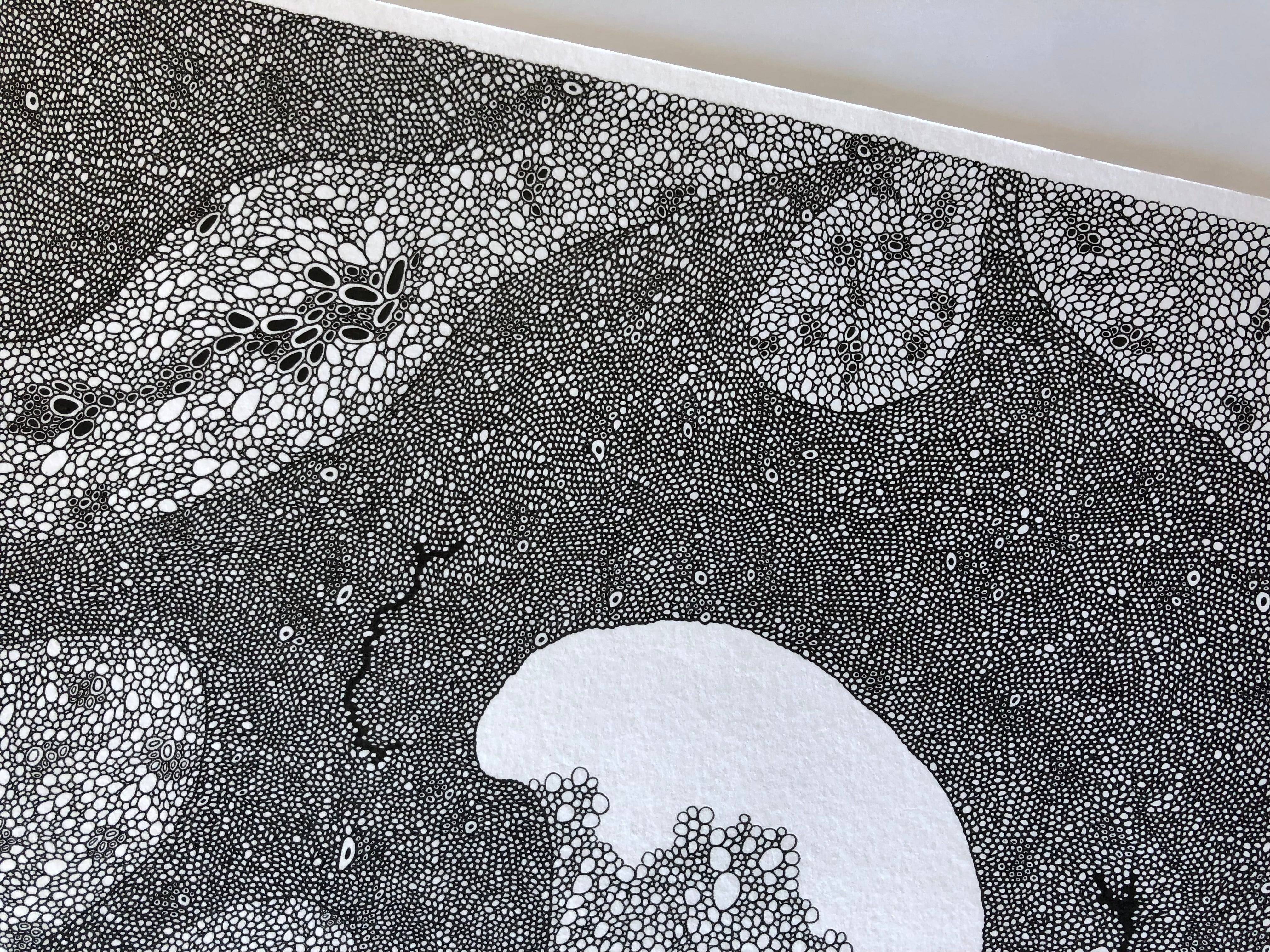 Hand drawing repeating circles on white paper as a mindful, meditative creative practice.